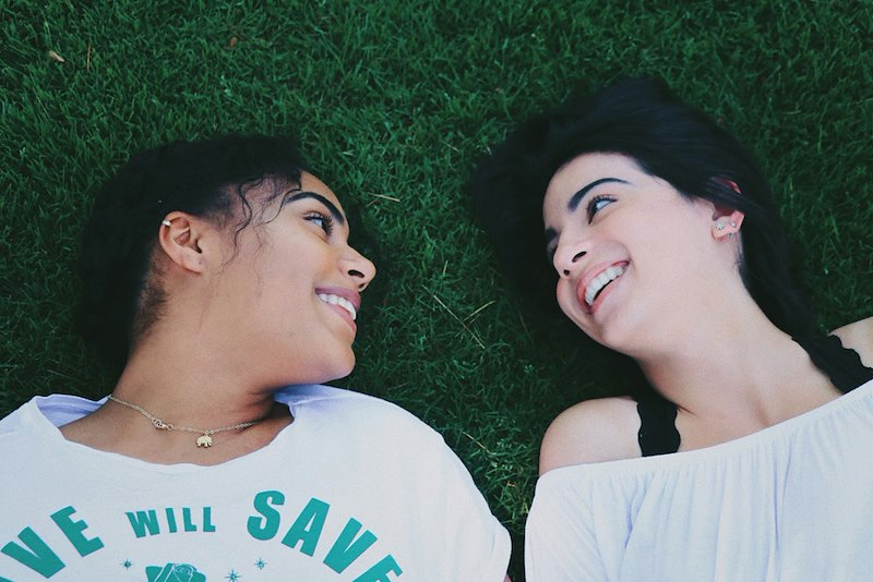 Two friends lying on the grass. Image is representative only and does not depict the actual subjects of the story.