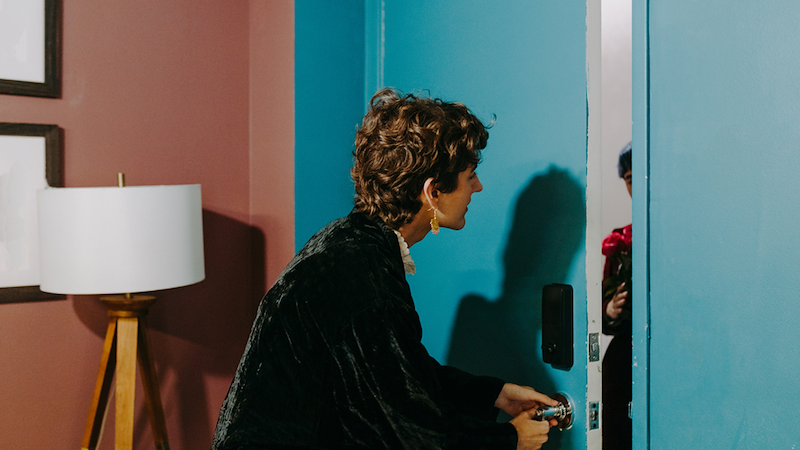 Woman opening a door.