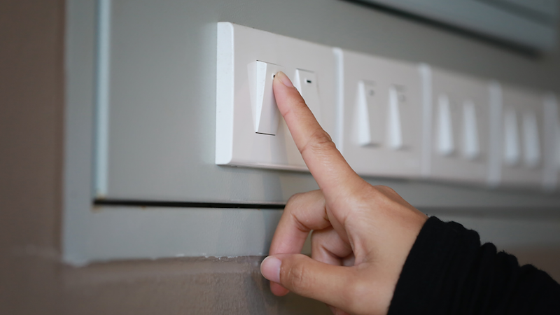 Turning off light switch in the office.