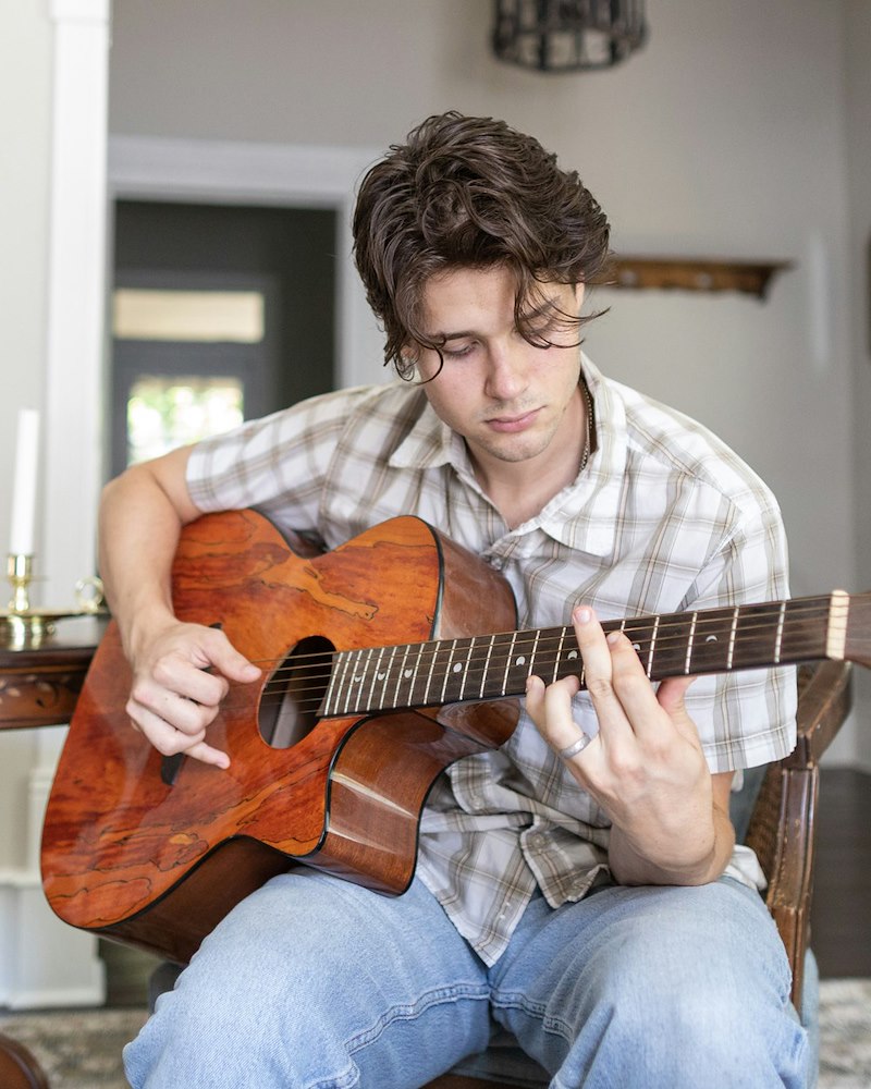A young musician plays guitar.