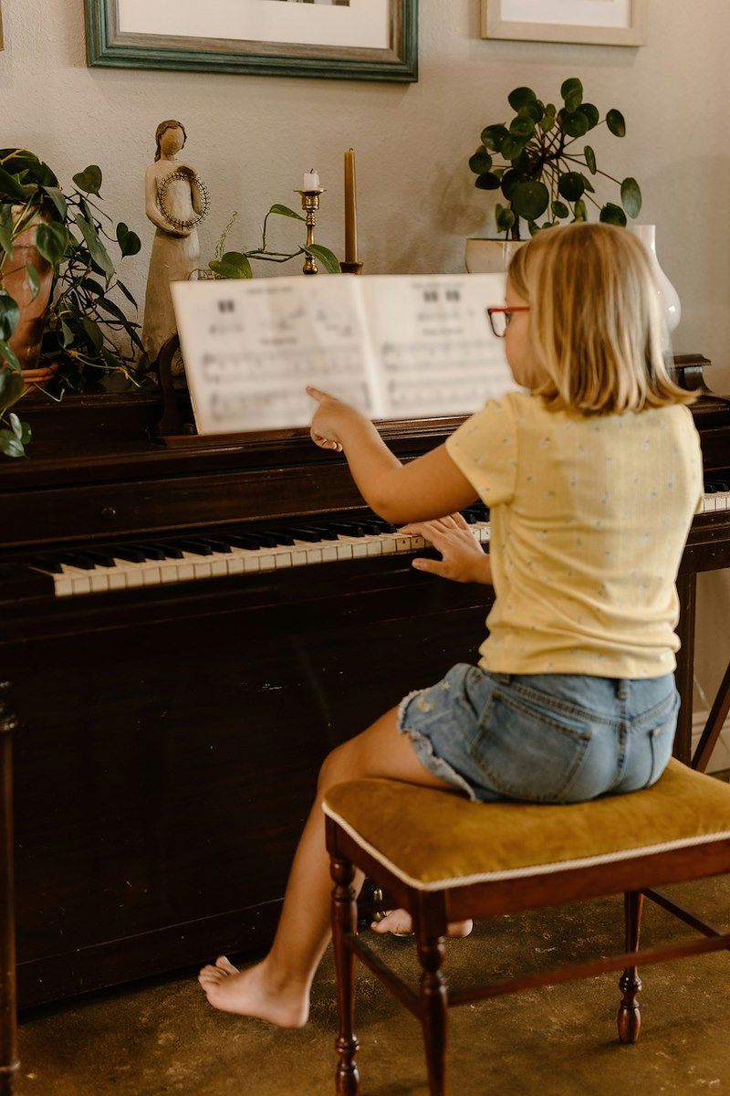 A talented young piano student practices piano.