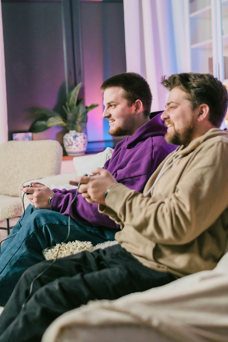 A couple of men sitting on top of a couch