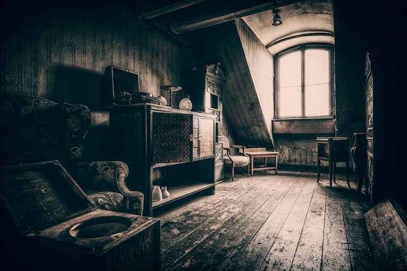 A dusty attic filled with old belongings.
