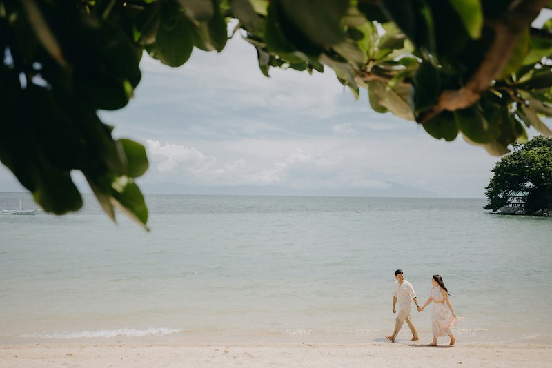 A couple walking on a beach on their honeymoon. Image is representative only and does not depict the actual subjects of the story.