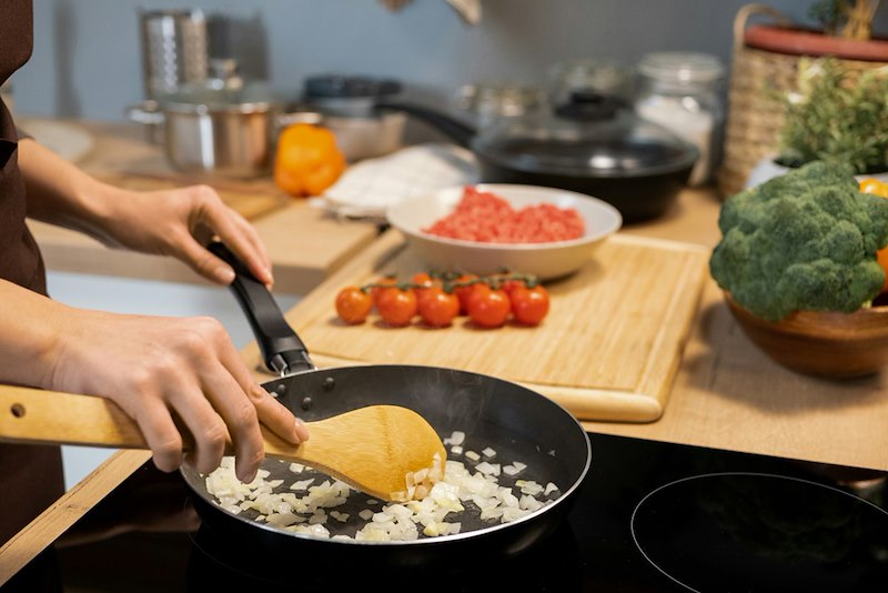 Person cooking a meal.