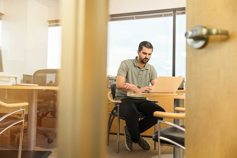 Man sitting alone at a desk, working.