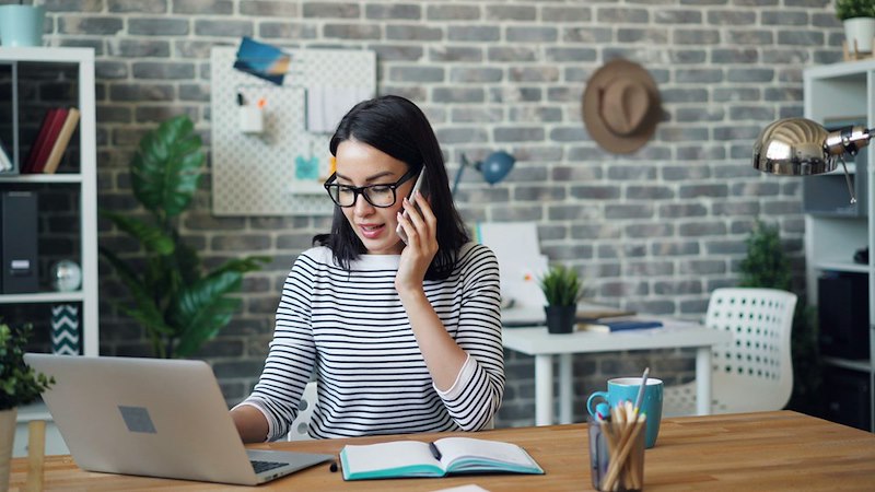 A personal assistant handling calls from customers. Individual pictured is a model used for illustrative purposes.