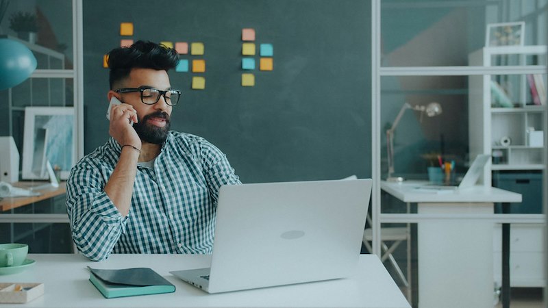 Employee takes a call at the office after being asked to train the person hired to take over his job for less money.