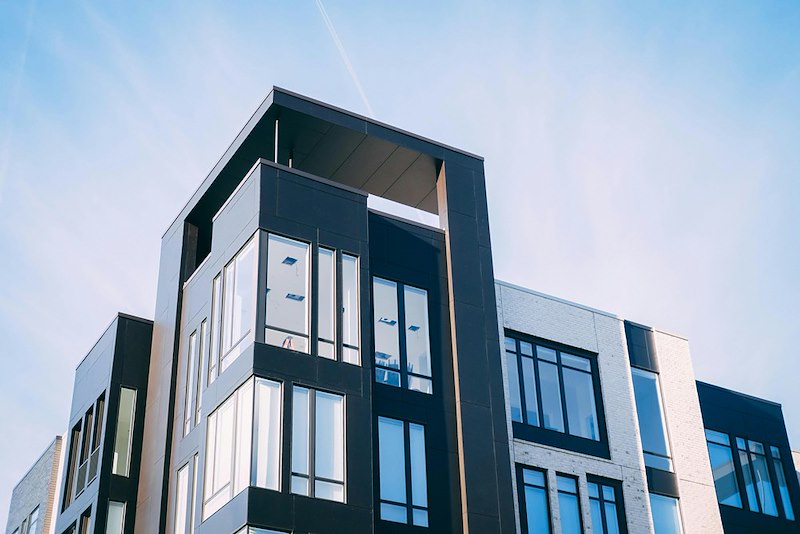 A modern apartment building with large windows.