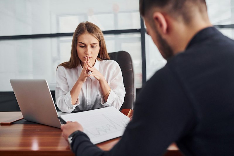 The employee discusses her performance with her boss.