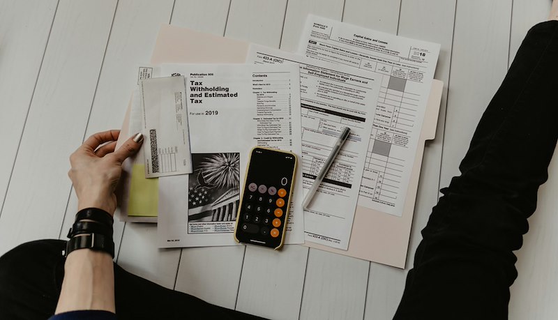A person doing maths about their spending habits. Stock photo unrelated.