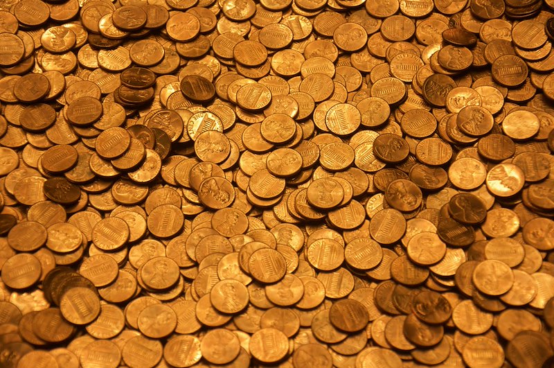 A lot of pennies in a table.