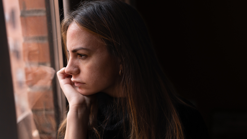 Upset woman staring out the window.