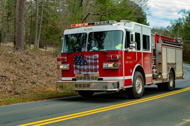 Red and white firetruck on the road during the daytime