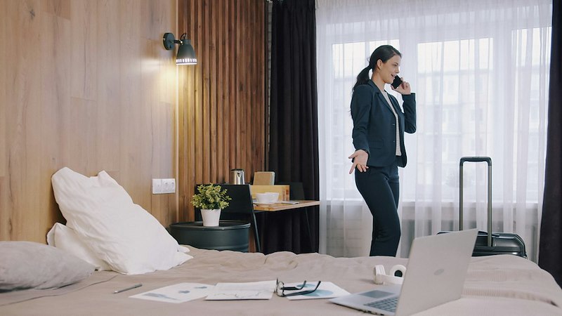 Woman working from a hotel room.