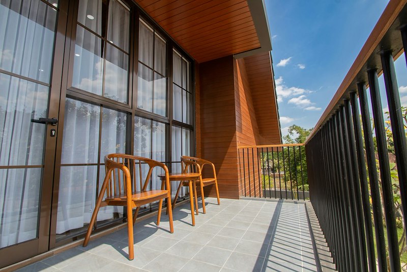 An apartment balcony with outdoor seating.