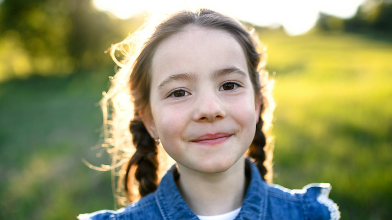 Close-up of a young girl outside.
