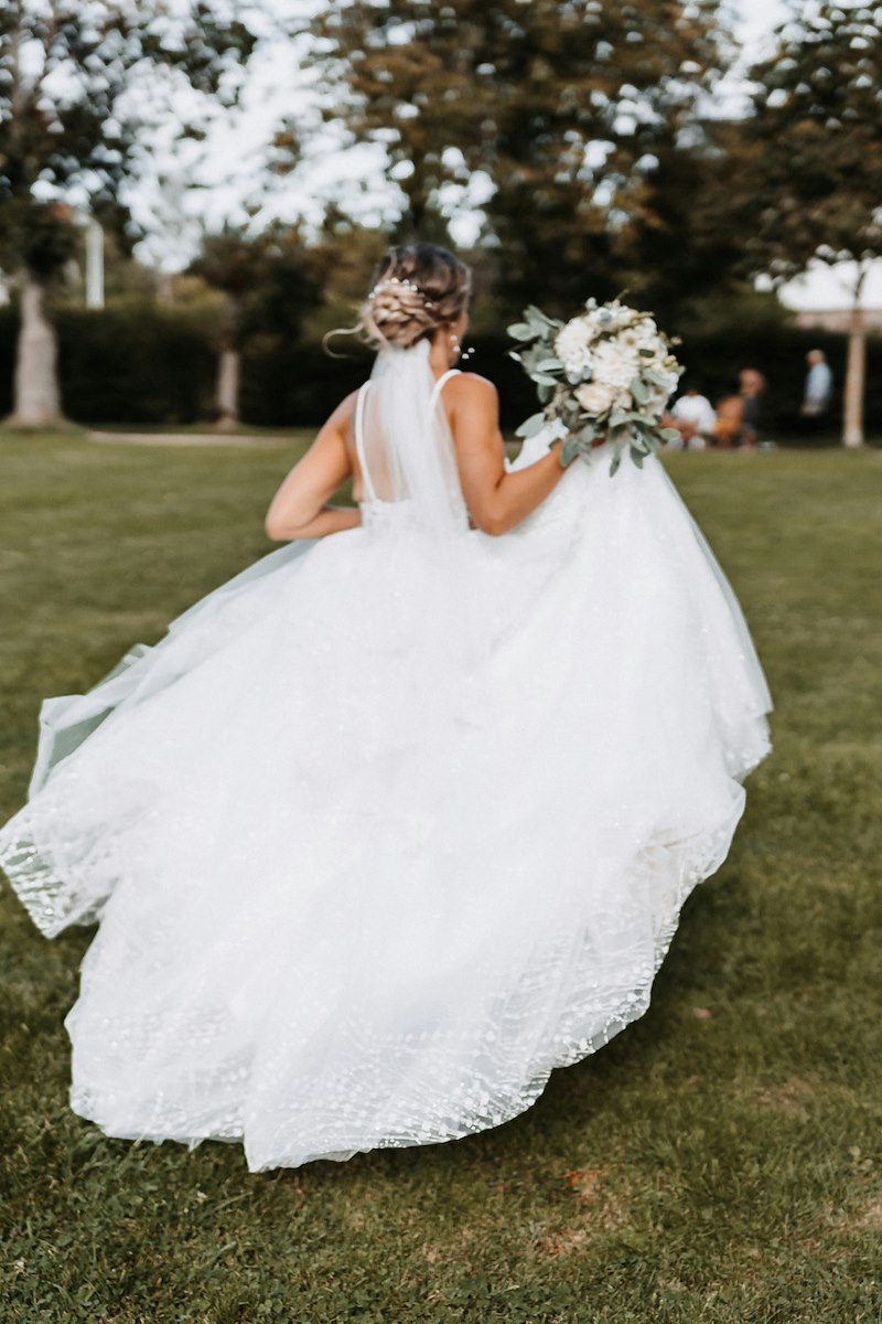The bride holding the bouquet demands a redo of the toss, claiming the guest is getting married next week.