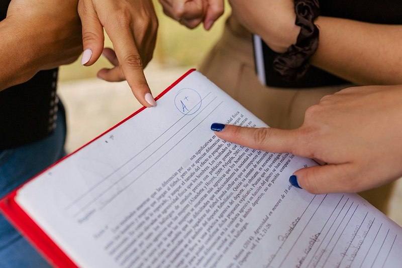 A close up of students looking at a test