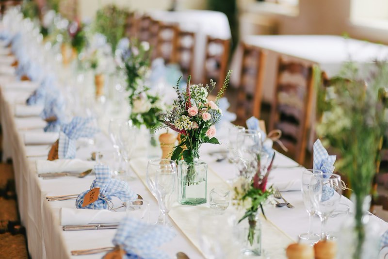 Elegant wedding reception table set for guests.