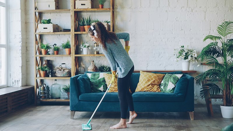 A woman cleaning a house, representing the younger sister who only cleans when asked.
