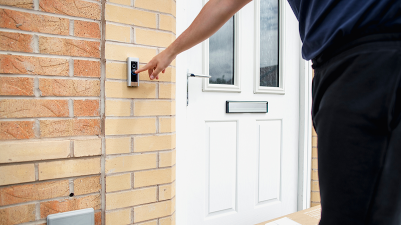 Person ringing doorbell.