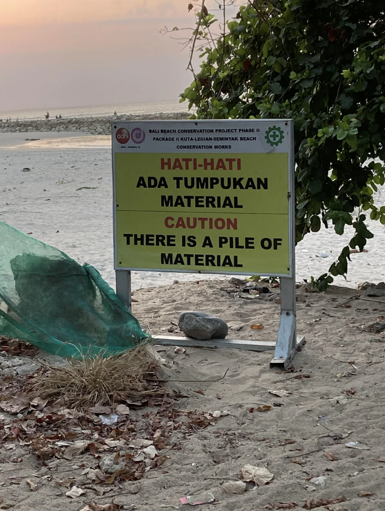 adhi BALI BEACH CONSERVATION PROJECT PHASE II PACKAGE II KUTA-LEGIAN-SEMINYAK BEACH CONSERVATION WORKS HATI-HATI ADA TUMPUKAN MATERIAL CAUTION THERE IS A PILE OF MATERIAL
