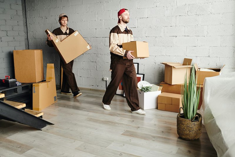The employees help move boxes.