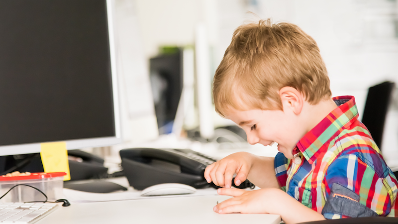 Kid playing in an office.