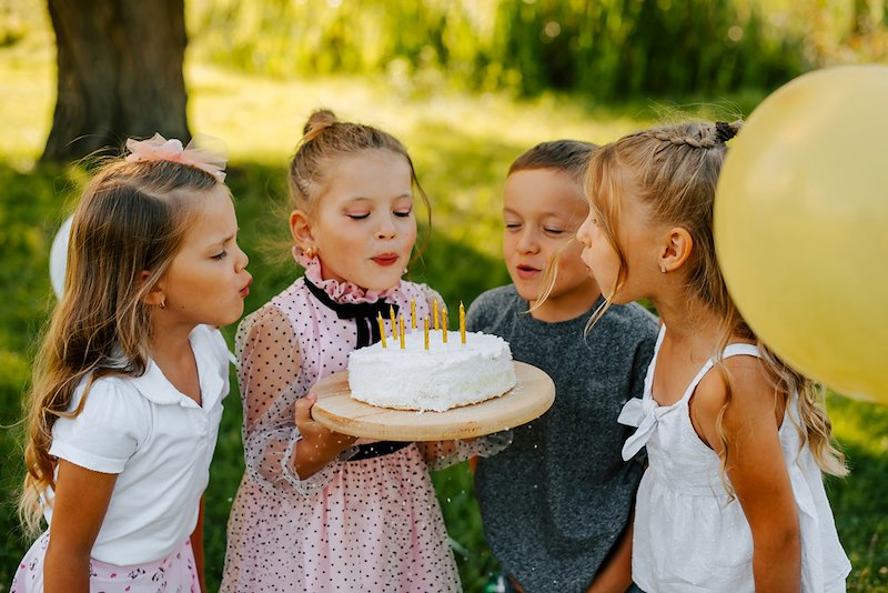 The birthday girl's whole class is invited for games and cake, and their parents are invited too.