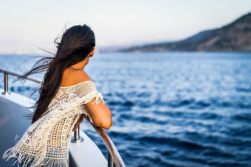 A woman enjoying her cruise ship vacation. Models pictured are not representative.
