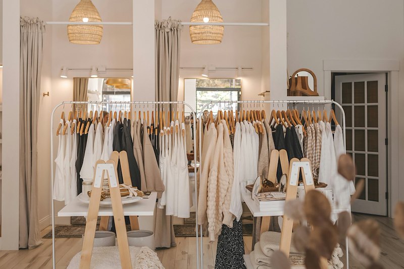 Interior of a clothing boutique with racks of fashionable apparel.