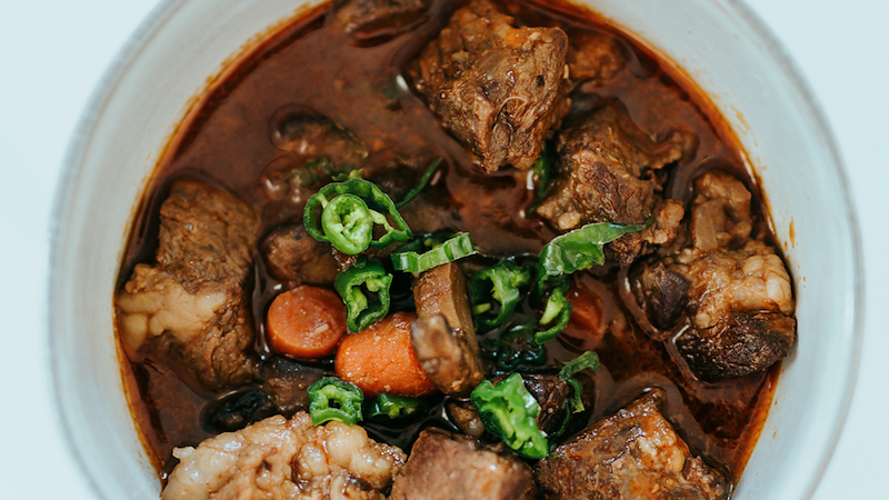 A top-down view of a bowl of meat stew.
