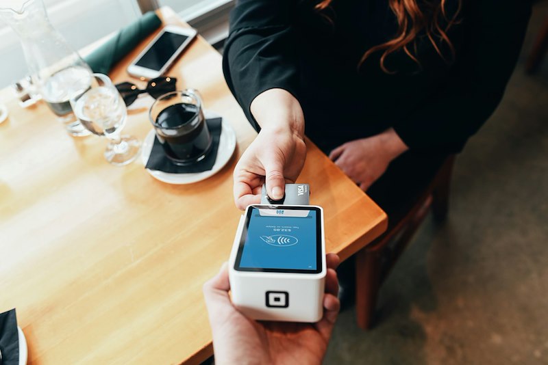 A person pays with a card in a card terminal