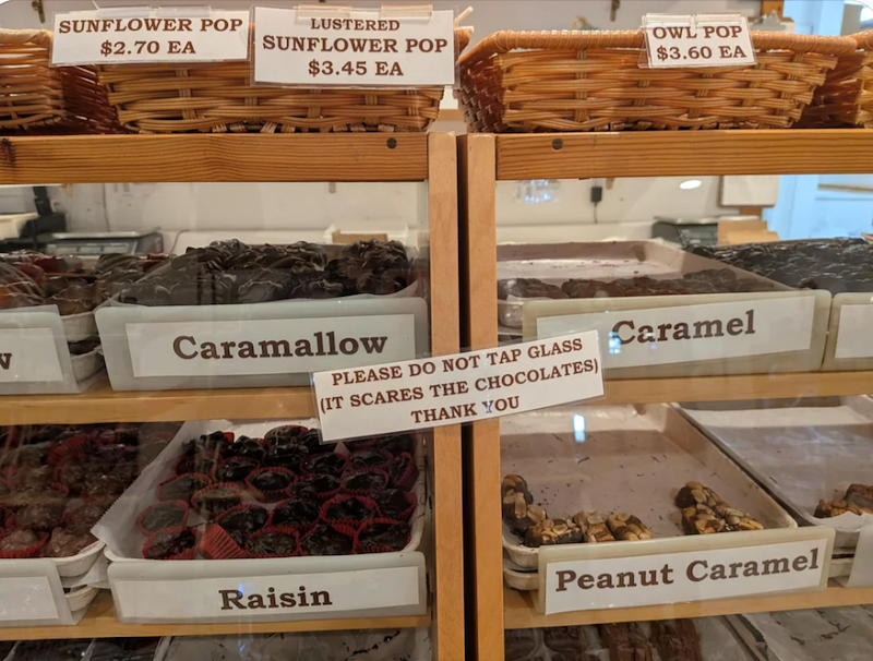 SUNFLOWER POP $2.70 EA LUSTERED SUNFLOWER POP $3.45 EA Caramallow PLEASE DO NOT TAP GLASS (IT SCARES THE CHOCOLATES) THANK YOU OWL POP $3.60 EA Caramel Raisin Peanut Caramel