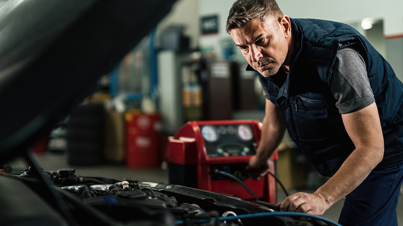 Car mechanic evaluating car damage