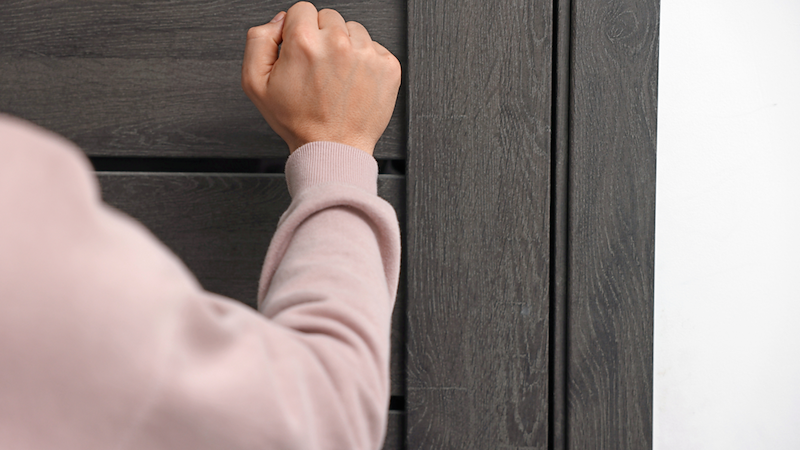 Woman insistently knocking on door