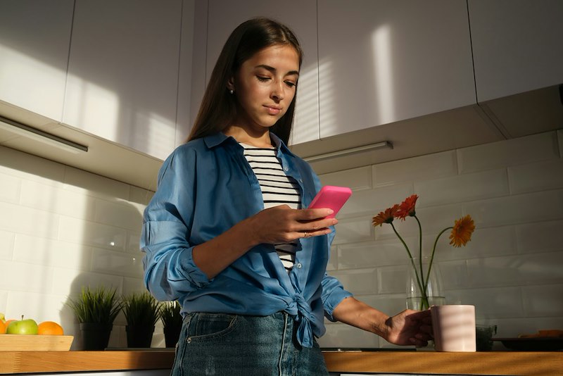 Woman checking her phone, learning that her concert ticket was originally meant for somebody else.