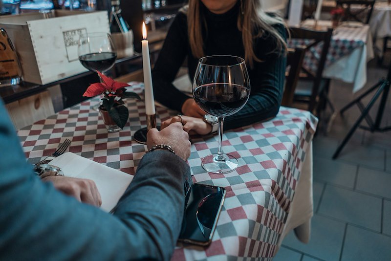 A man and a woman holds hands at a table