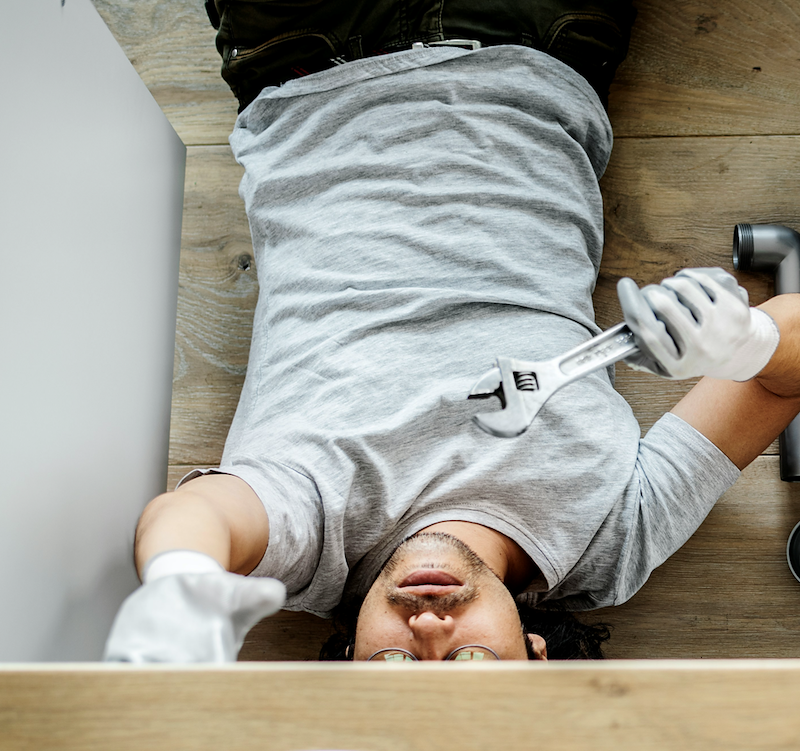 The nephew repairs a sink, one of his many contributions to maintenance around the home that the homeowners had been meaning to get to