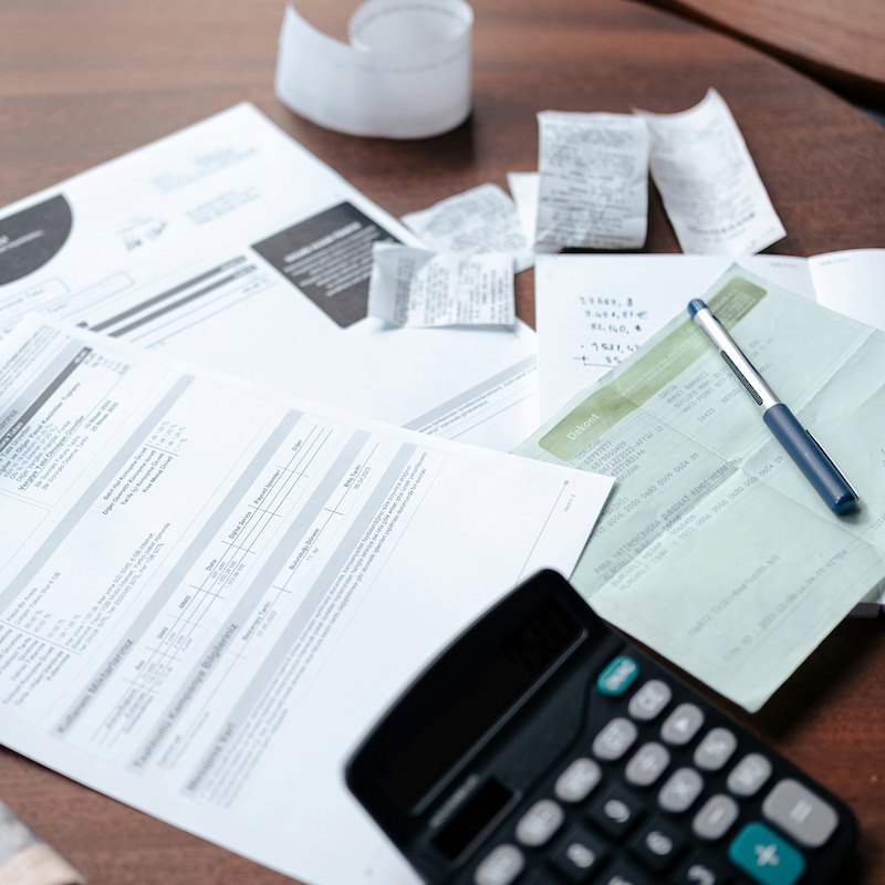 Bills and a calculator that a 29-year-old daughter is expected to pay after starting her first job.