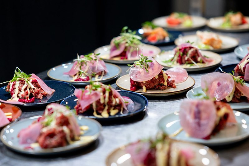 The plates the caterer serves to the guests.