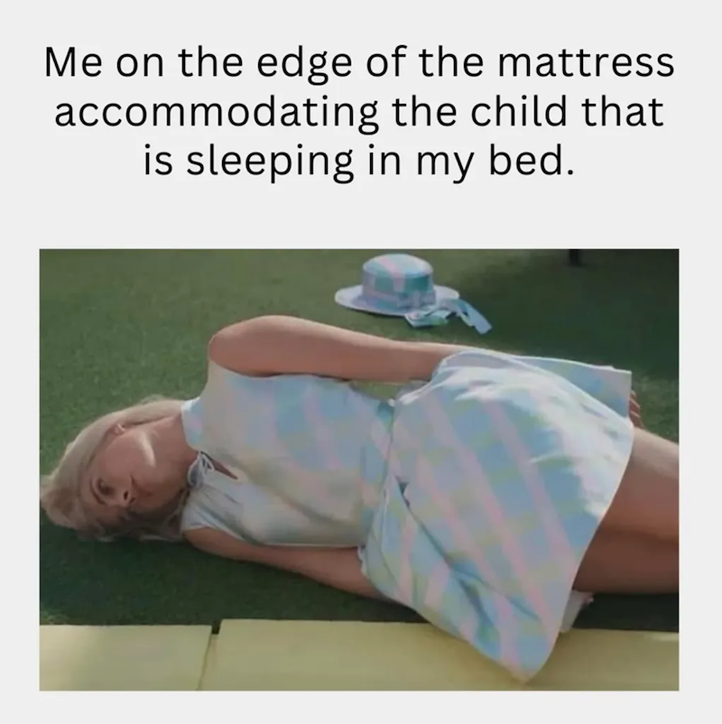 Me on the edge of the mattress accommodating the child that is sleeping in my bed.