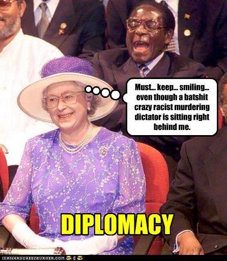 Must... keep... smiling... even though a batshit crazy racist murdering dictator is sitting right behind me.