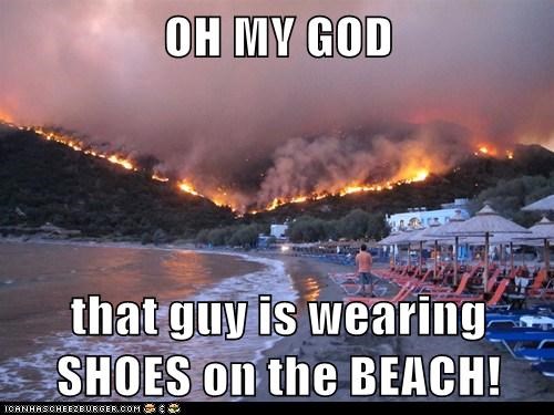 OH MY GOD  that guy is wearing SHOES on the BEACH!