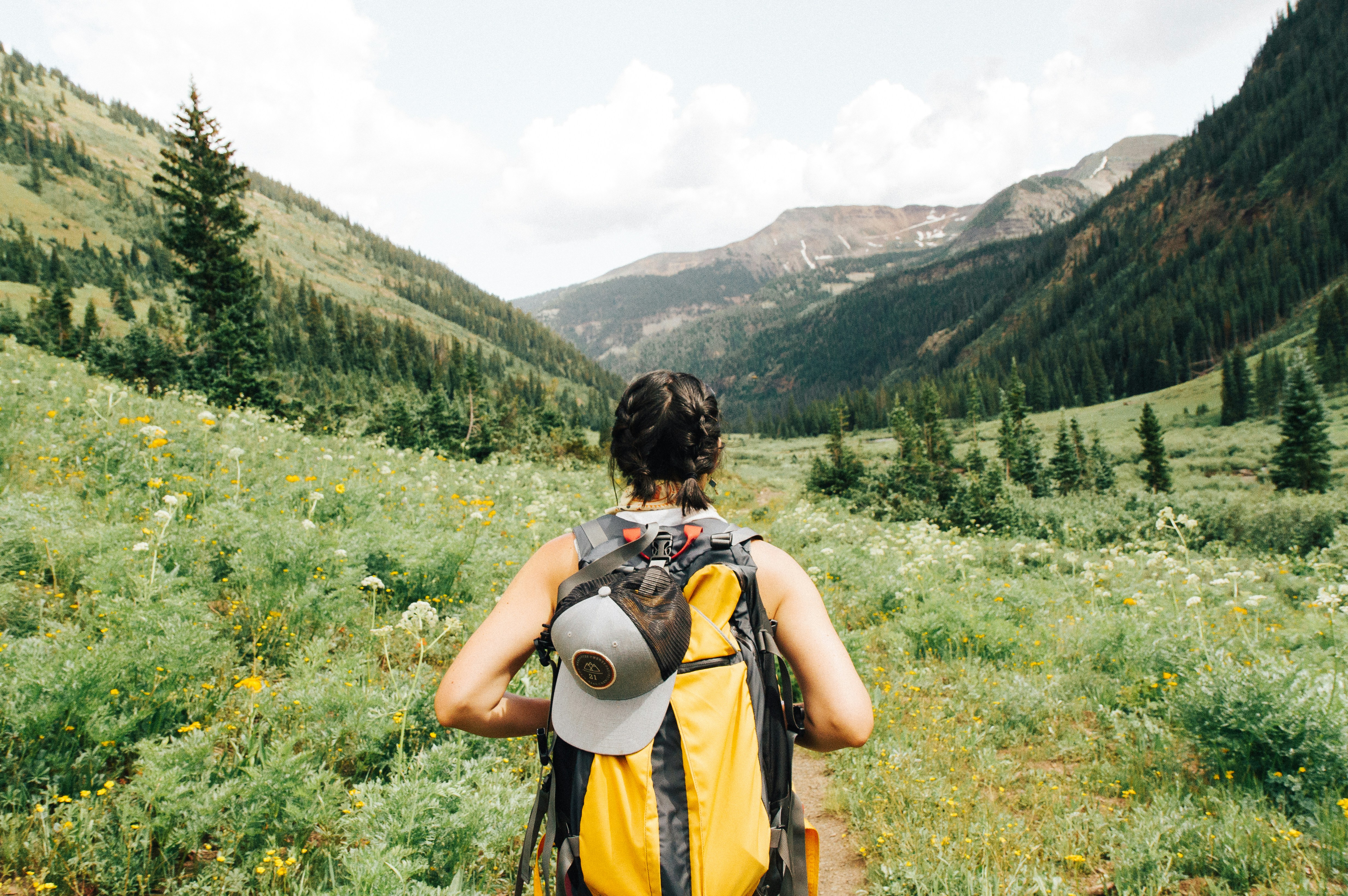 Woman gets invited to a hike by her friends, only to discover it was not what she was told. Everyone appears with utilities and then acts as if they had explained how it was going to be: 'They show up on bikes.'