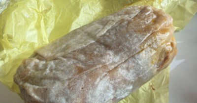 Woman unapologetically eats a giant burrito at her desk to rebel against the workplace Karen who critiques her lunches every day:' I made eye contact while I took the first bite'