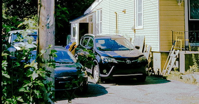 Business owner lets customers park in neighbor's driveway, gets annoyed when he starts charging $10 for parking: 'I'd asked him to stop several times'