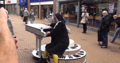 Dafuq of the Day: Man Dressed as a Nun Rides Around the Streets Entertaining on a Motorized Piano