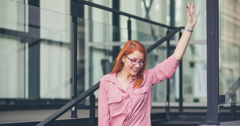 A happy woman leaves her office to pick up her kids, who do not exist.